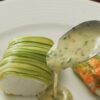 Merlu, rubans de courgette, fleur de courgette farcie et beurre blanc aux herbes